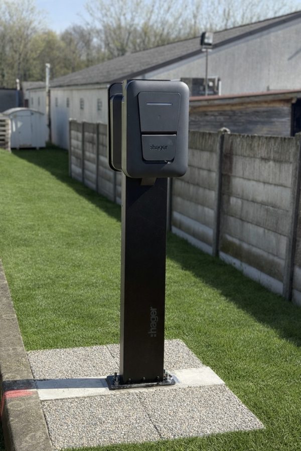 Borne de recharge Hager noire installée sur un pied en extérieur